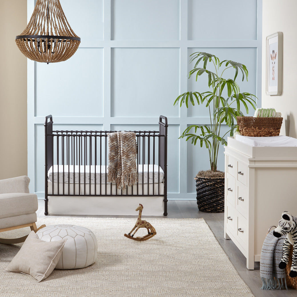 Namesake's Wesley Farmhouse 6-Drawer Double Dresser next to a crib in -- Color_Hairloom White