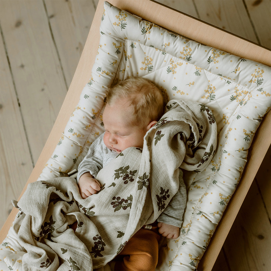 Top view of baby sleeping in the Charlie Crane LEVO Baby Rocker in -- Color_Garbo And Friends Mimosa _ Beech