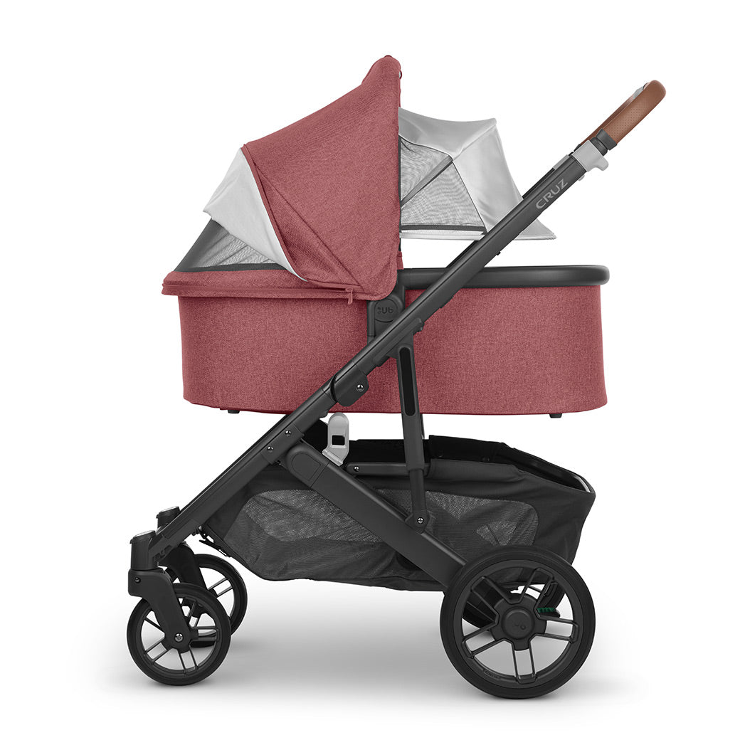 Side view of UPPAbaby Bassinet on a stroller with the canopy down and extended in -- Color_Lucy