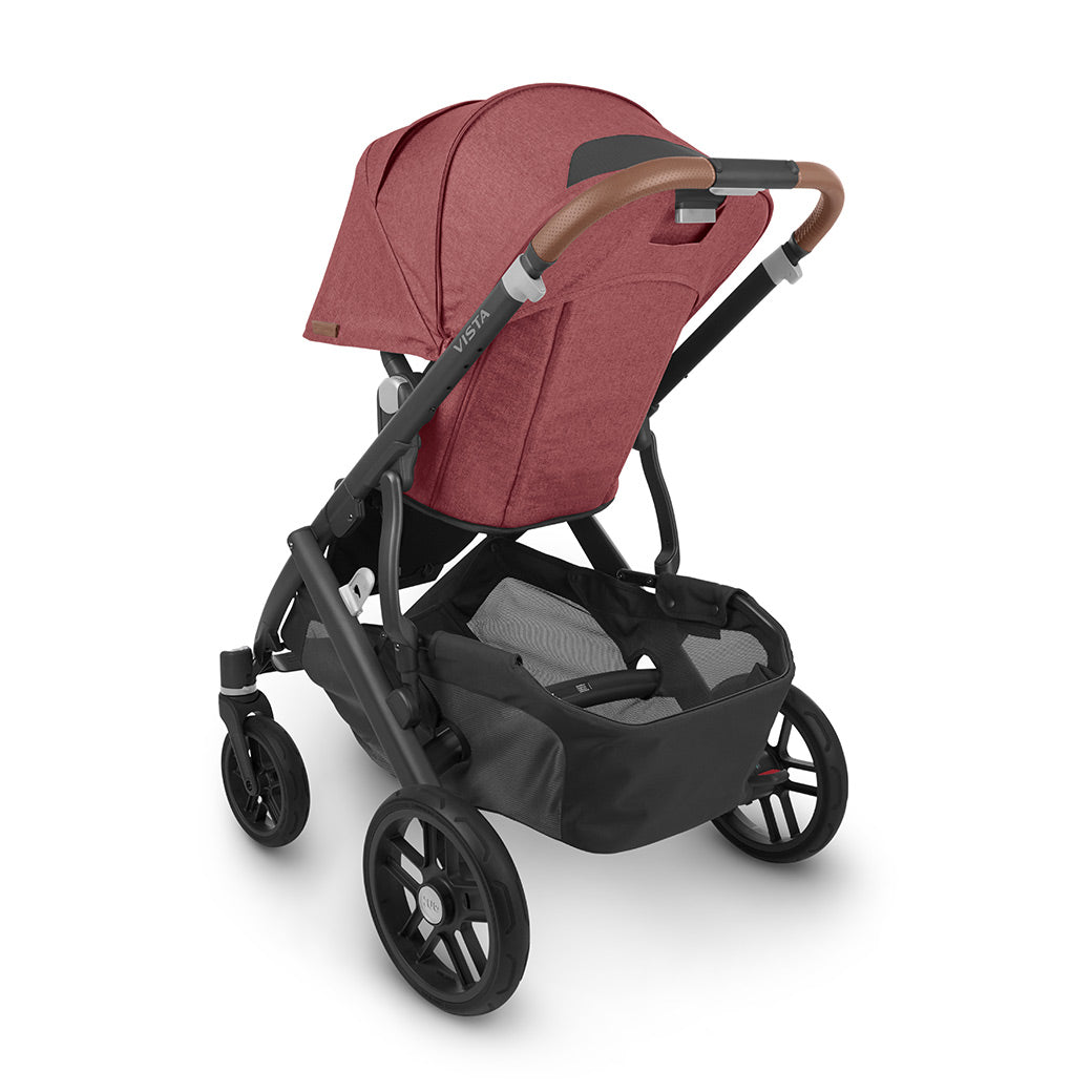 Rear-view of the uppababy vista v2 stroller showing the ample storage basket and leatherette handlebar details -- Color_Lucy