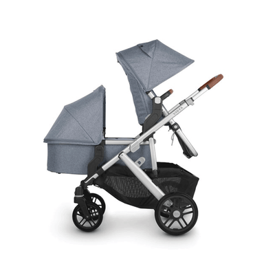Side view of UPPAbaby Vista V2 Twin Stroller with one bassinet below one seat -- Color_Gregory