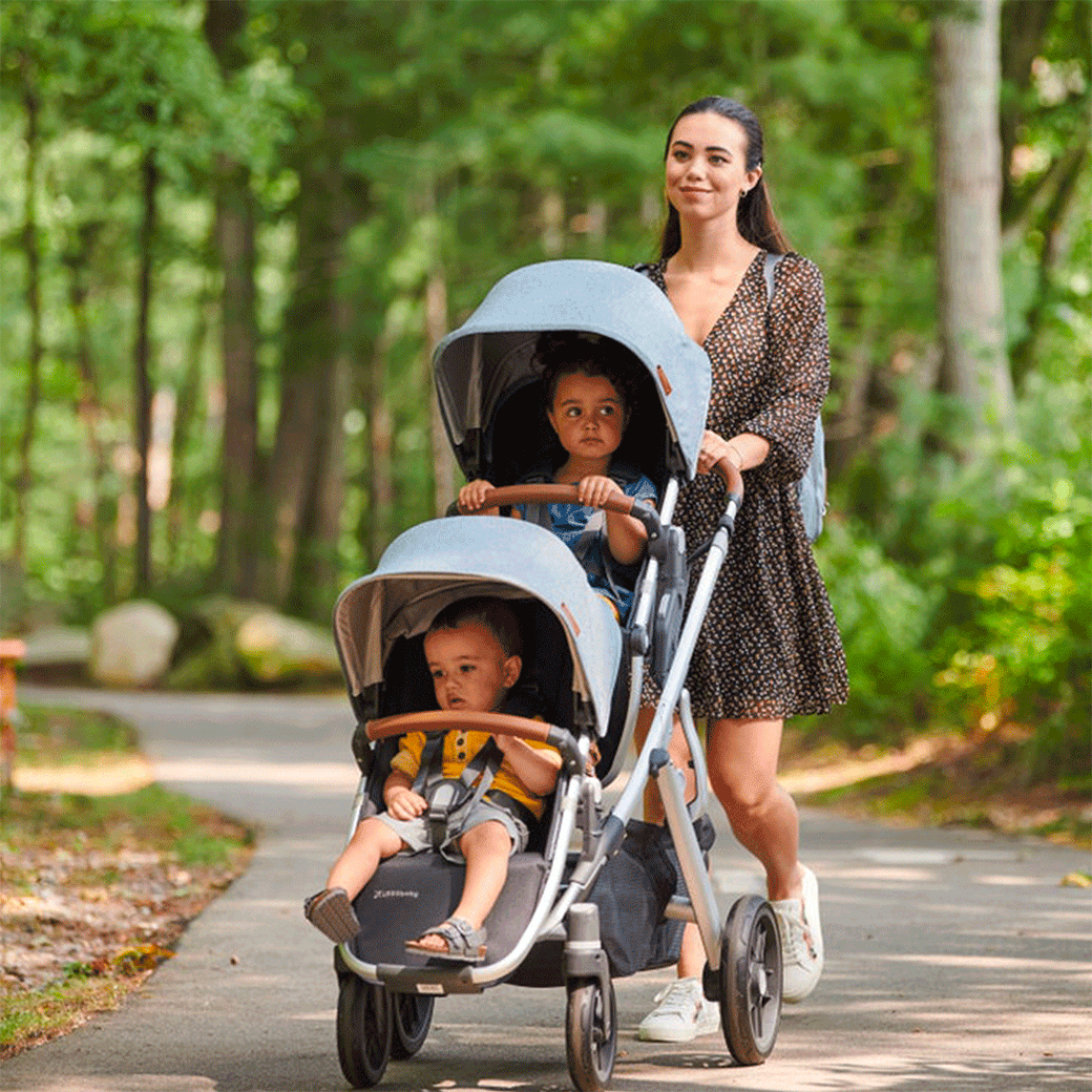 Mom walking her two kids in the UPPAbaby Vista V2 Twin Stroller in Gregory -- Lifestyle