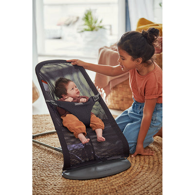 Girl talking to baby in BABYBJÖRN Bouncer Bliss in -- Color_Anthracite (Slate Gray) MeshBABYBJÖRN Bouncer Bliss in -- Color_Anthracite (Slate Gray) Mesh