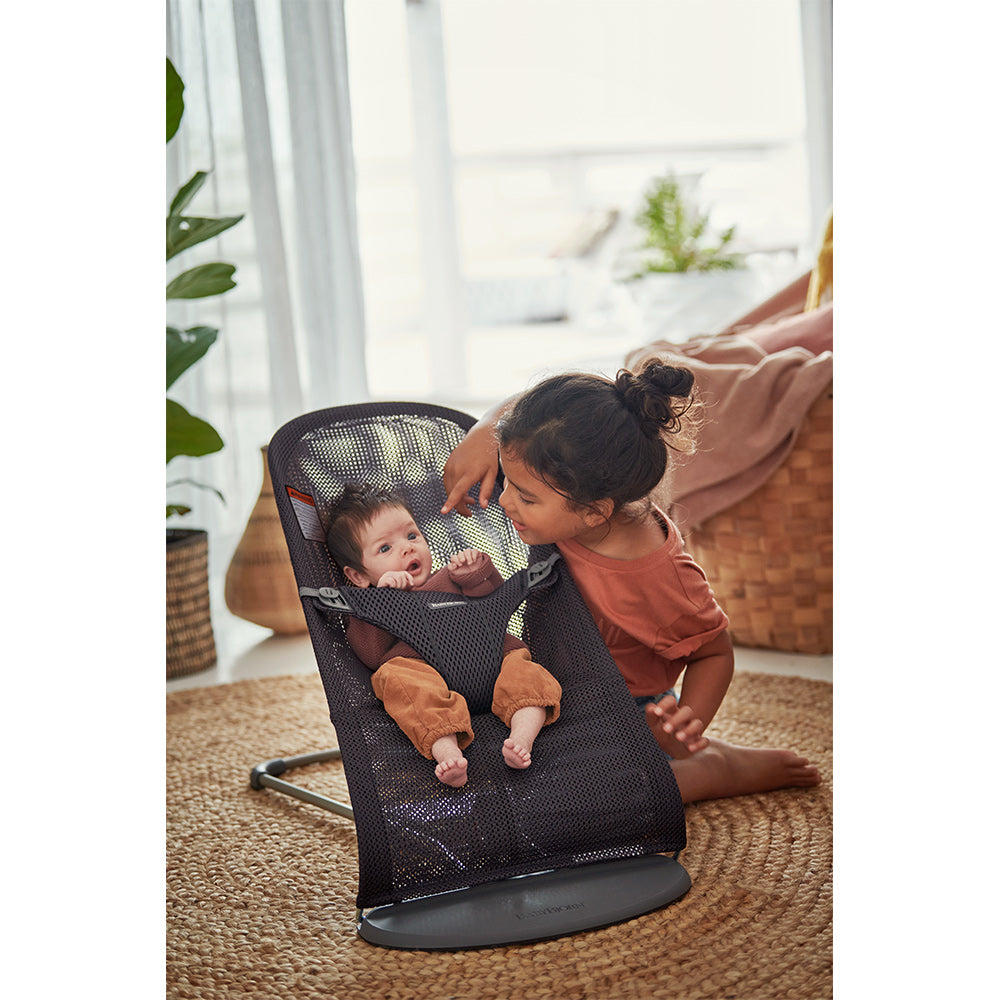 Girl playing with baby in BABYBJÖRN Bouncer Bliss in -- Color_Anthracite (Slate Gray) Mesh