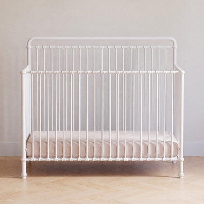 Front view of Namesake's Winston 4 in 1 Convertible Crib in a room in -- Color_Washed White