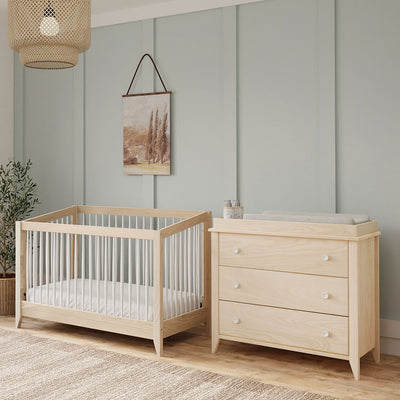 Babyletto's Sprout 4-in-1 Convertible Crib next to a dresser in -- Color_Washed Natural / White