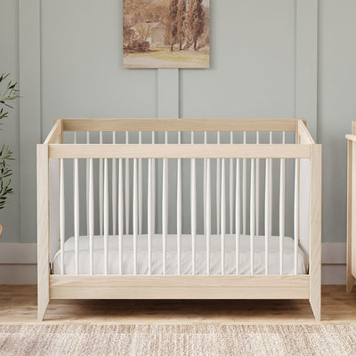 Front view of Babyletto's Sprout 4-in-1 Convertible Crib in a room in -- Color_Washed Natural / White