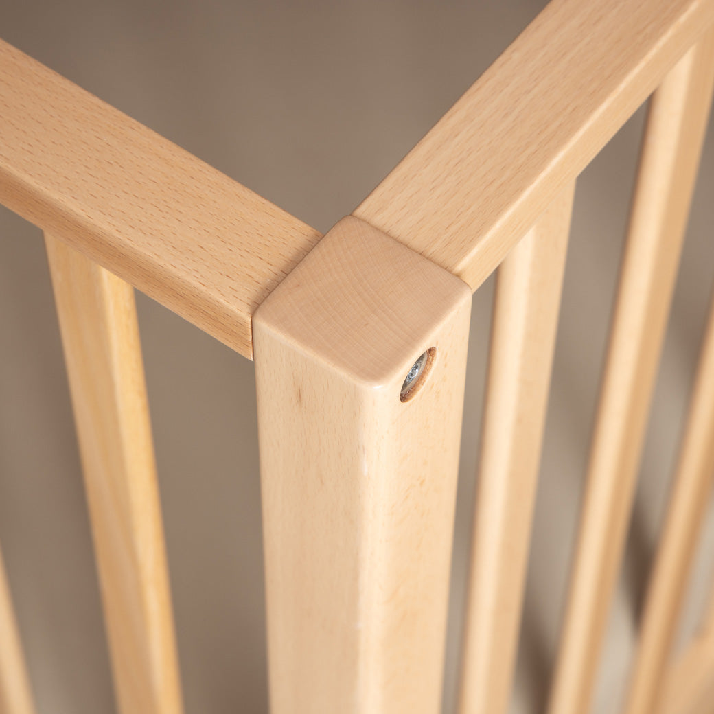 Closeup of Dadada Lala 3-in-1 Convertible Crib rails connecting in - Color_Natural