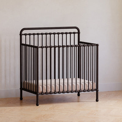 Namesake's Winston 4-in-1 Convertible Mini Crib in a room in -- Color_Vintage Iron