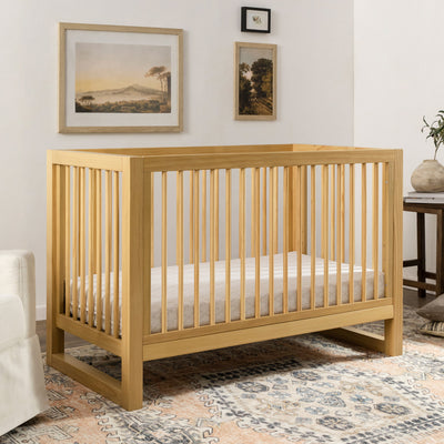 Namesake's Nantucket 3-in-1 Convertible Crib in a cozy room in -- Color_Honey