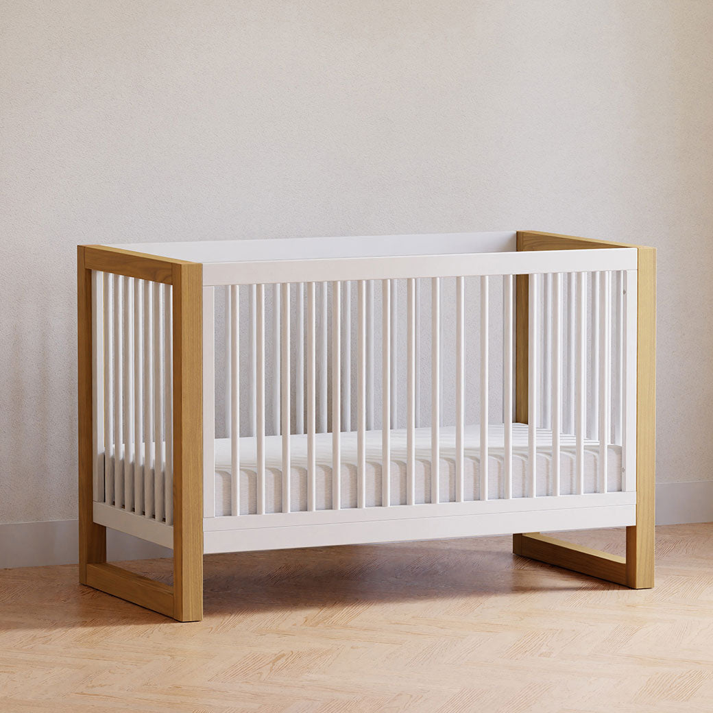 Namesake's Nantucket 3-in-1 Convertible Crib in a room in -- Color_Warm White/Honey