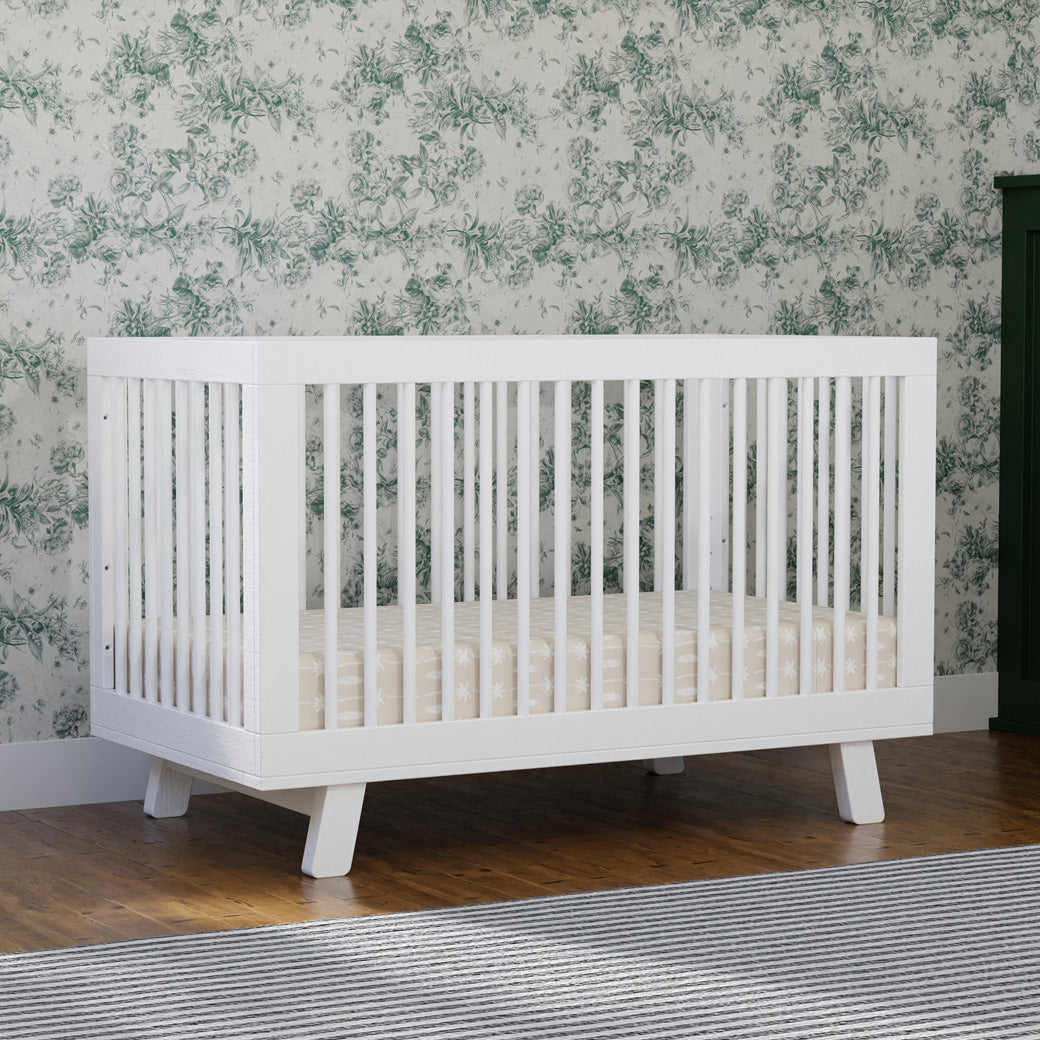 Babyletto Hudson 3-in-1 Crib in a room with a green pattern  in -- Color_White