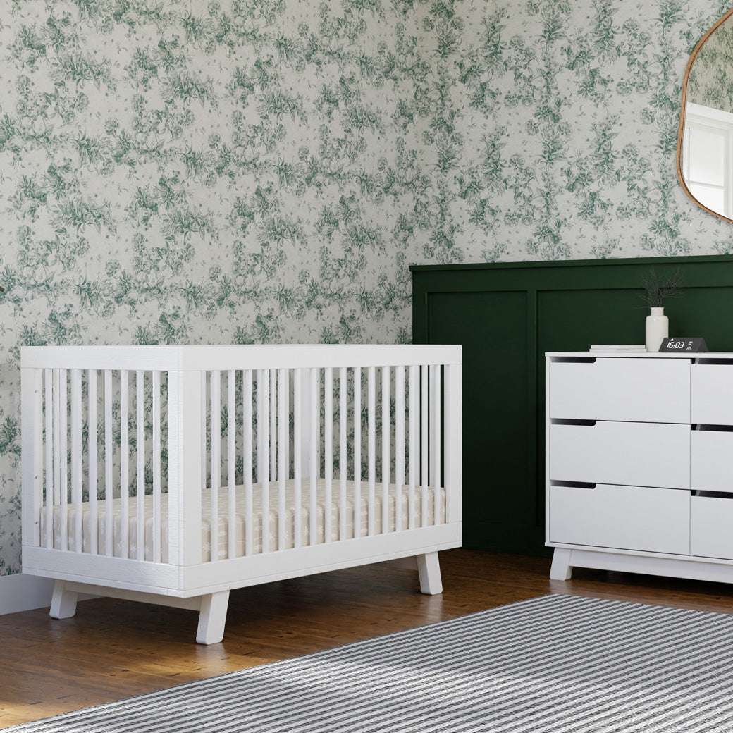 Babyletto Hudson 3-in-1 Crib next to a dresser in -- Color_White