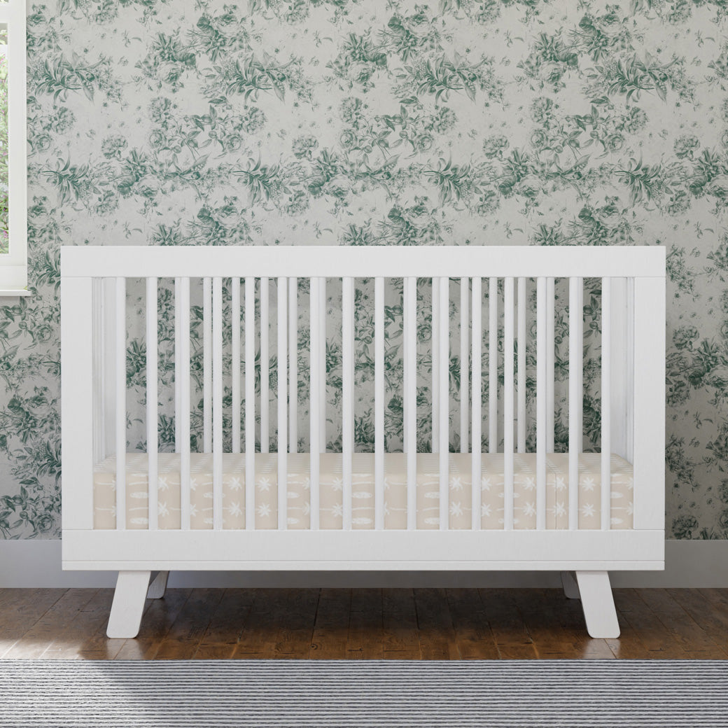 Front view of Babyletto Hudson 3-in-1 Crib in a room with green pattern in -- Color_White