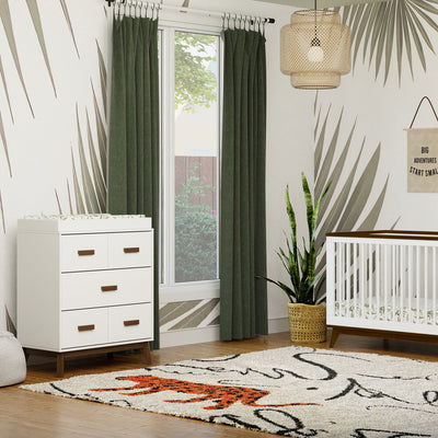 Babyletto's Scoot 3-Drawer Changer Dresser next to a white and walnut crib in -- Color_White/Natural Walnut
