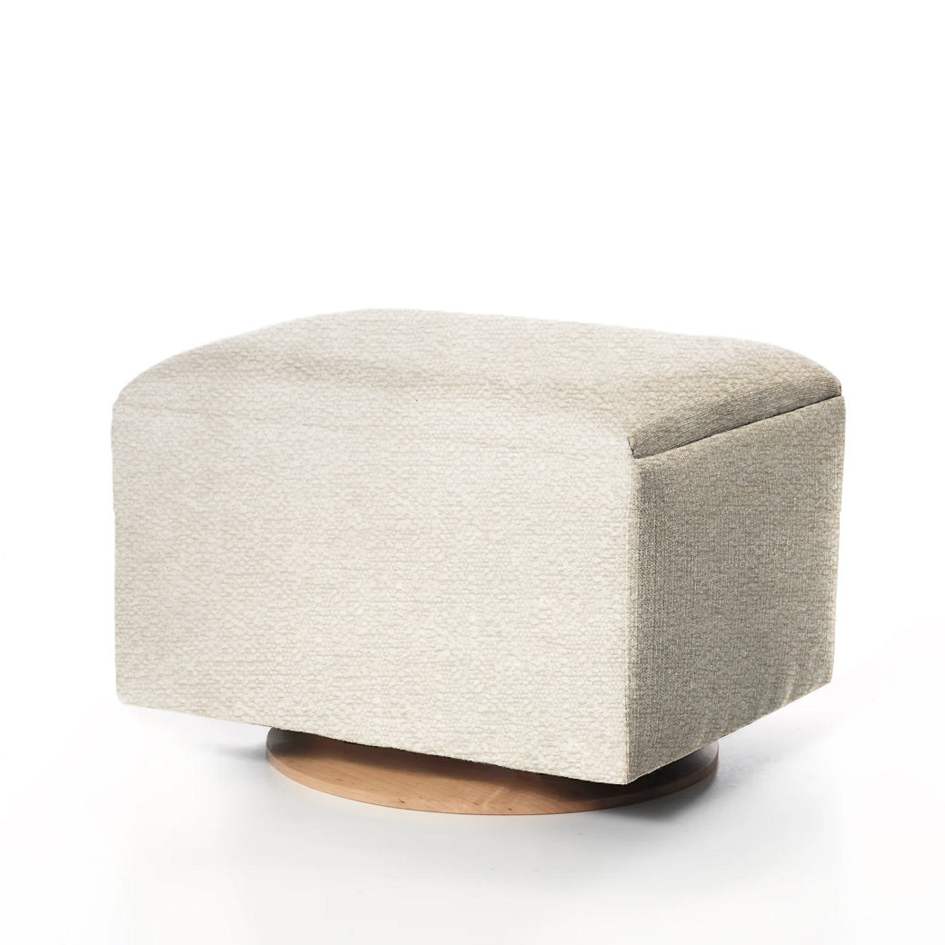 Creamed off-white ottoman with light fabric and wooden base.