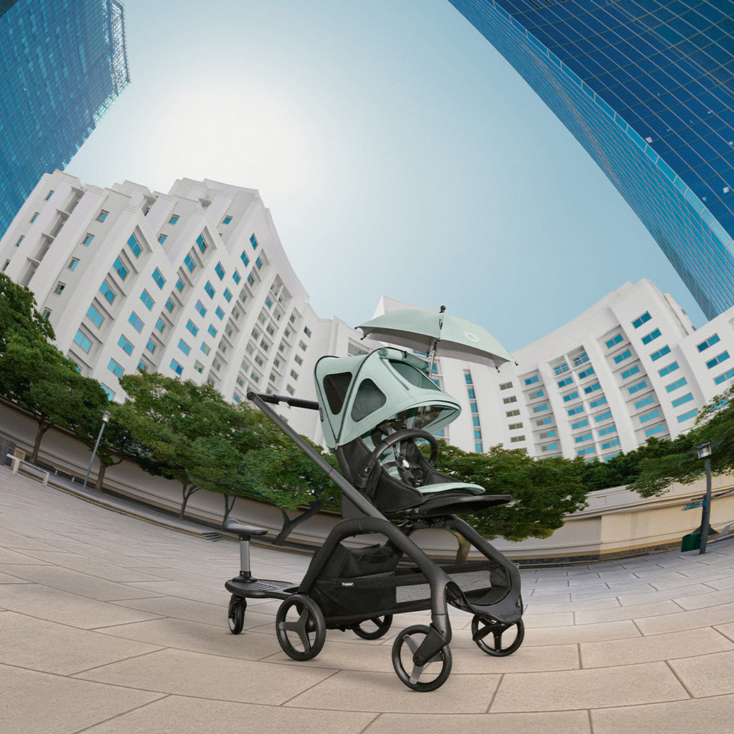 Bugaboo Dragonfly Breezy Sun Canopy on a stroller in the street  in -- Color_Pine Green
