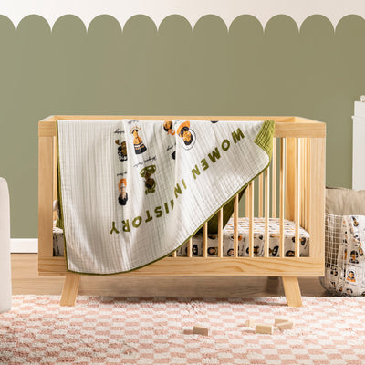 Babyletto's Quilt In 3-Layer GOTS Certified Organic Muslin Cotton hanging from a crib in -- Color_Women In History