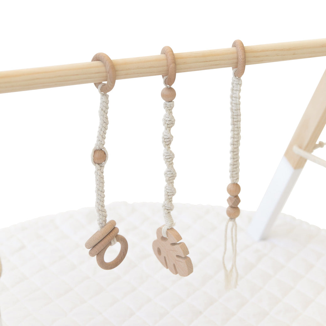 Closeup of toys of Poppyseed Play Wood Baby Gym + Toys in -- Color_White _ Macrame