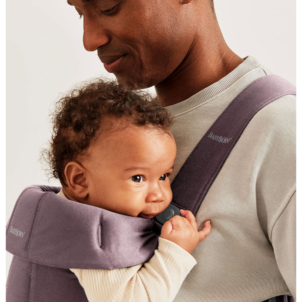 Closeup of dad carrying baby in BABYBJÖRN Baby Carrier Mini with top part down in -- Color_Dark Purple Woven