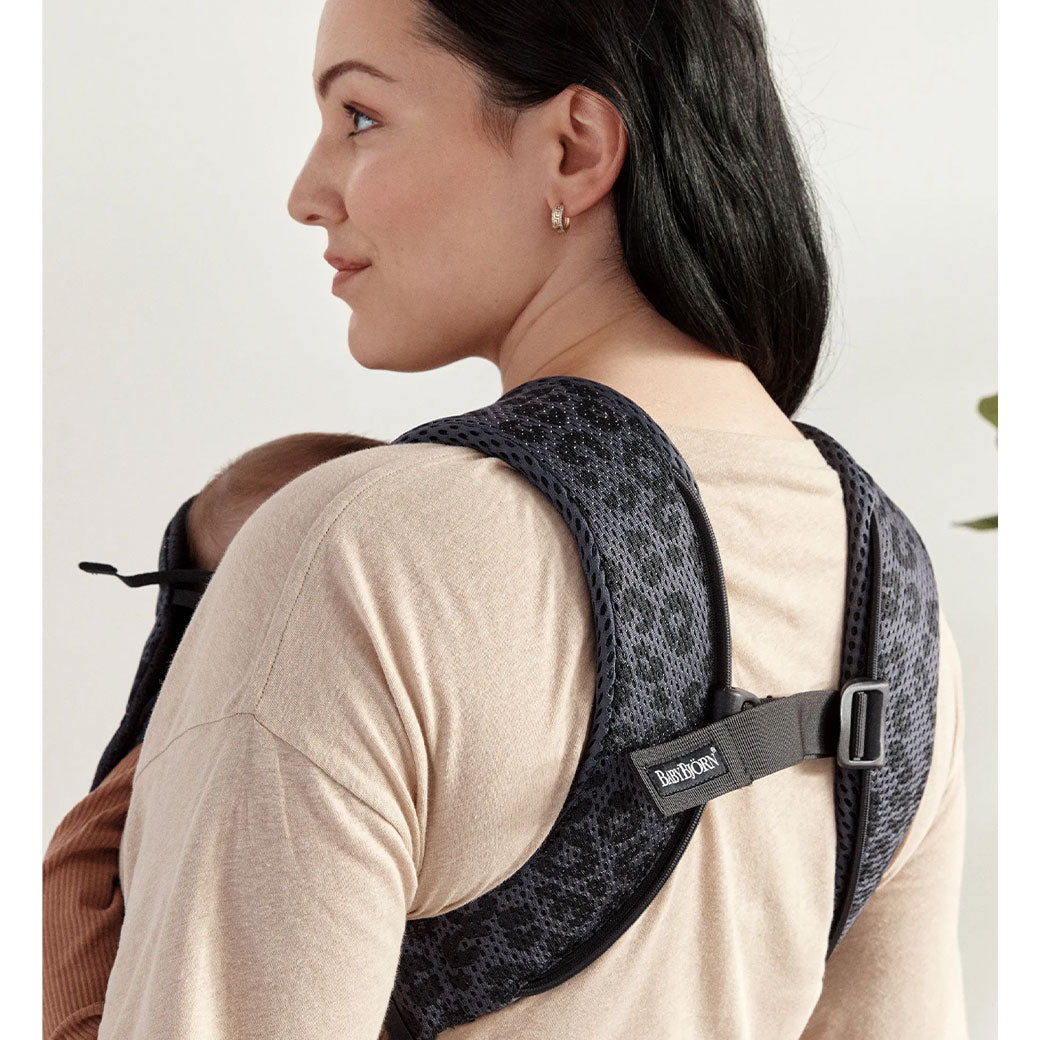 Back view of mom with baby in Babybjorn Baby Carrier One in -- Color_Anthracite Leopard 3D Mesh Air