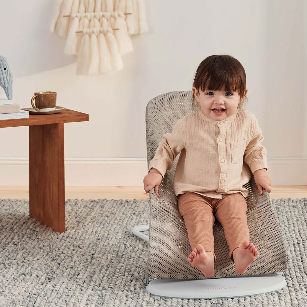 Toddler sitting  in BABYBJÖRN Bouncer Balance Soft in -- Color_Grey Beige/White Mesh