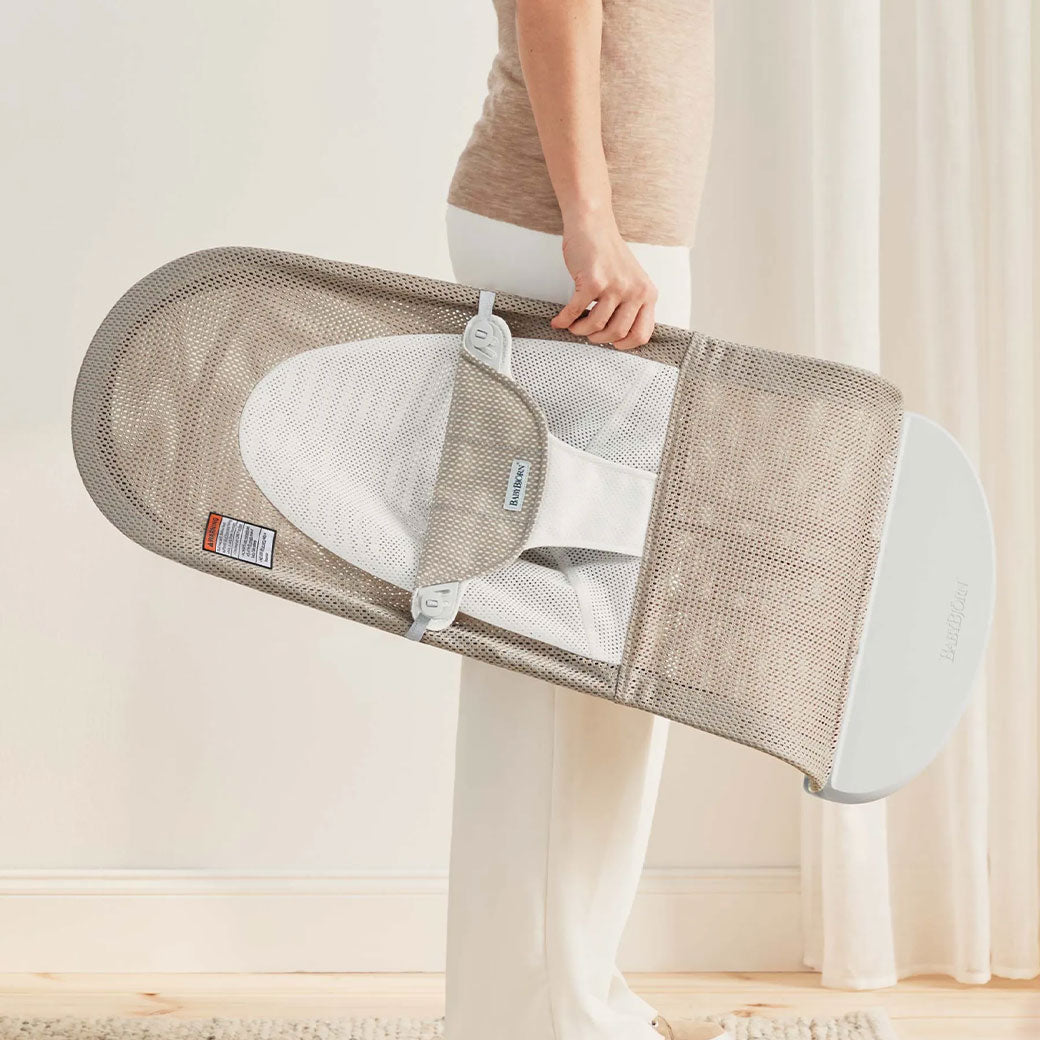 Mom holding BABYBJÖRN Bouncer Balance Soft in -- Color_Grey Beige/White Mesh