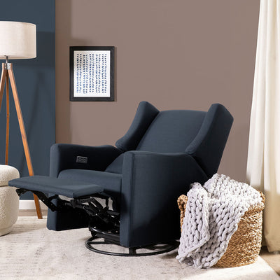 Fully reclined Babyletto Kiwi Glider Recliner next to a basket in -- Color_Performance Navy Eco-Twill