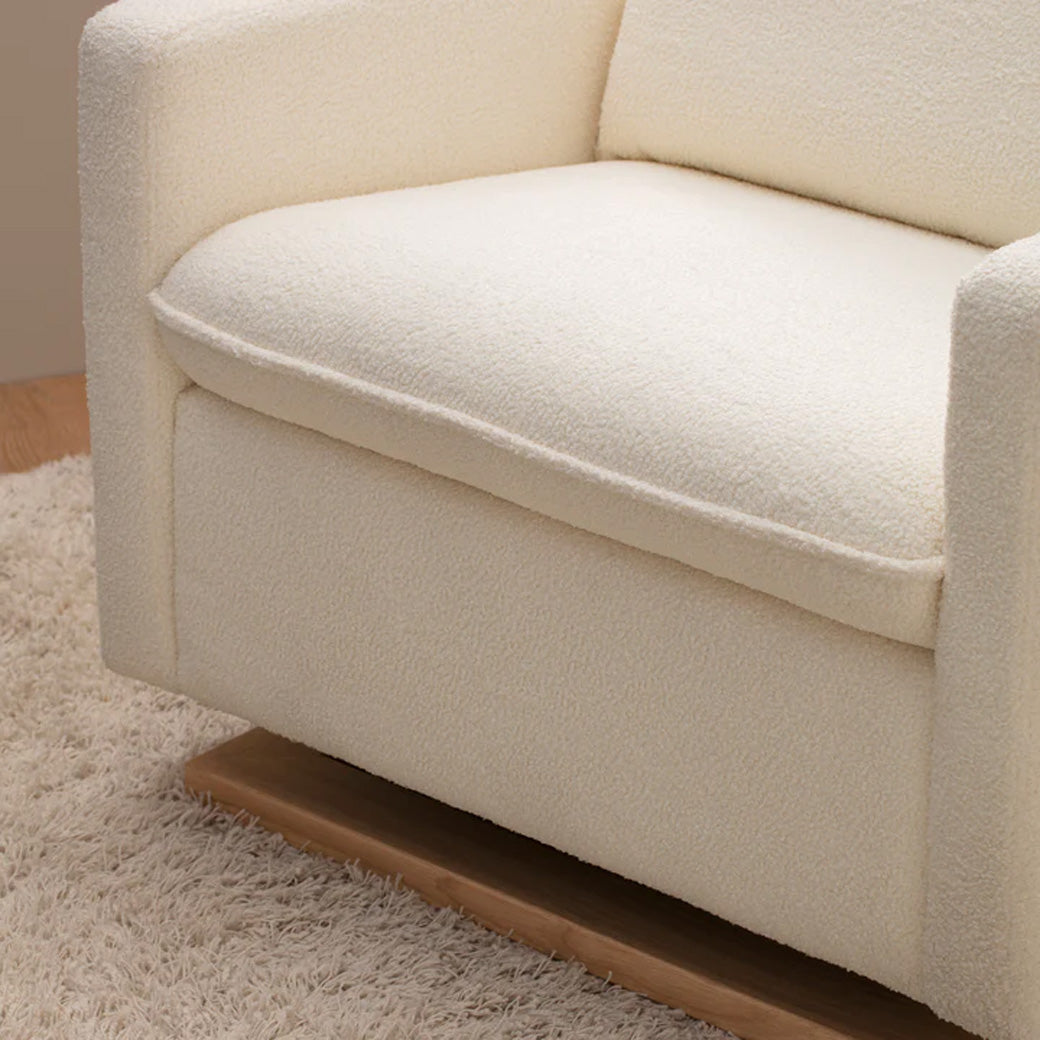 Closeup of Babyletto Cali Pillowback Chair-and-a-Half Glider on rug in -- Color_Chantilly Sherpa with Light Wood Base