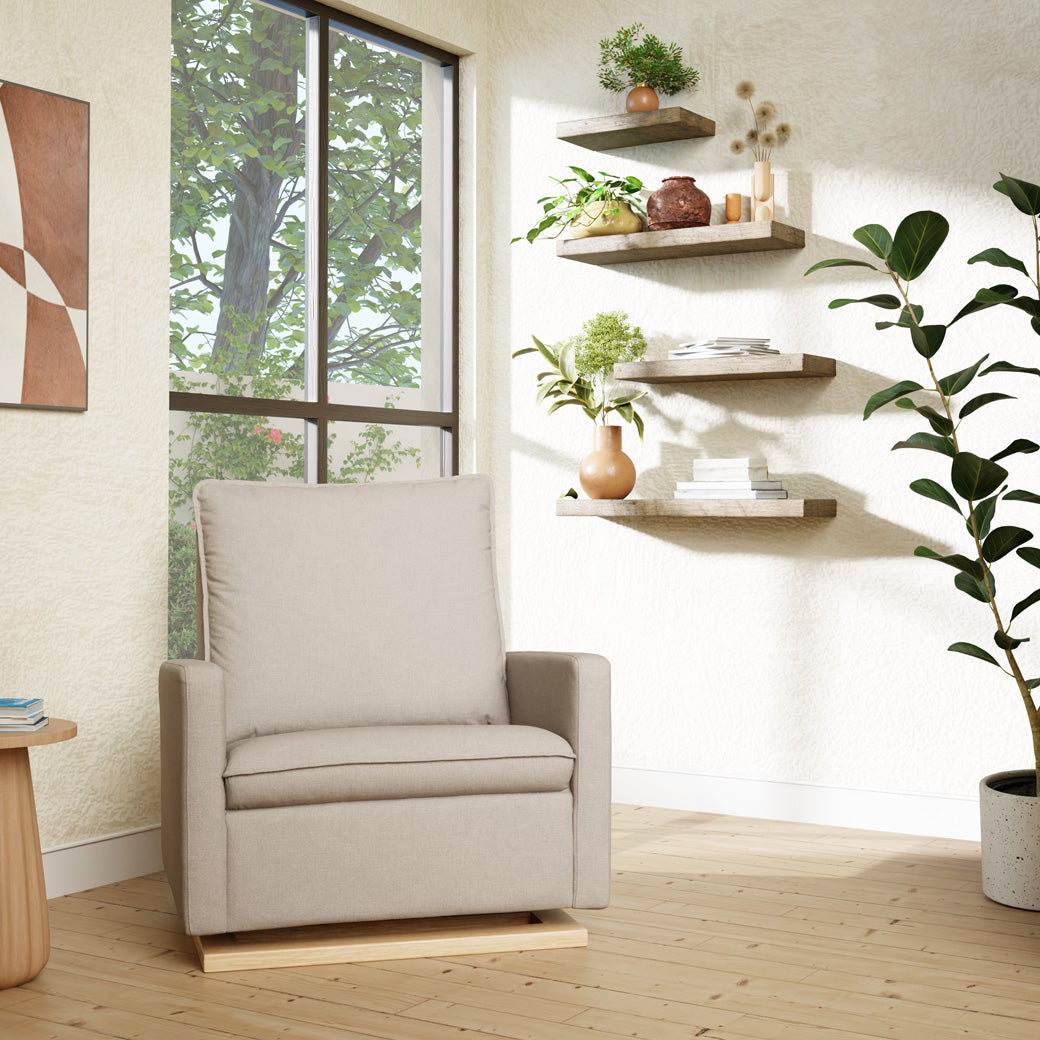 Babyletto Cali Pillowback Chair-and-a-Half Glider next to window, bookshelves and plant  in -- Color_Performance Beach Eco-Weave with Light Wood Base