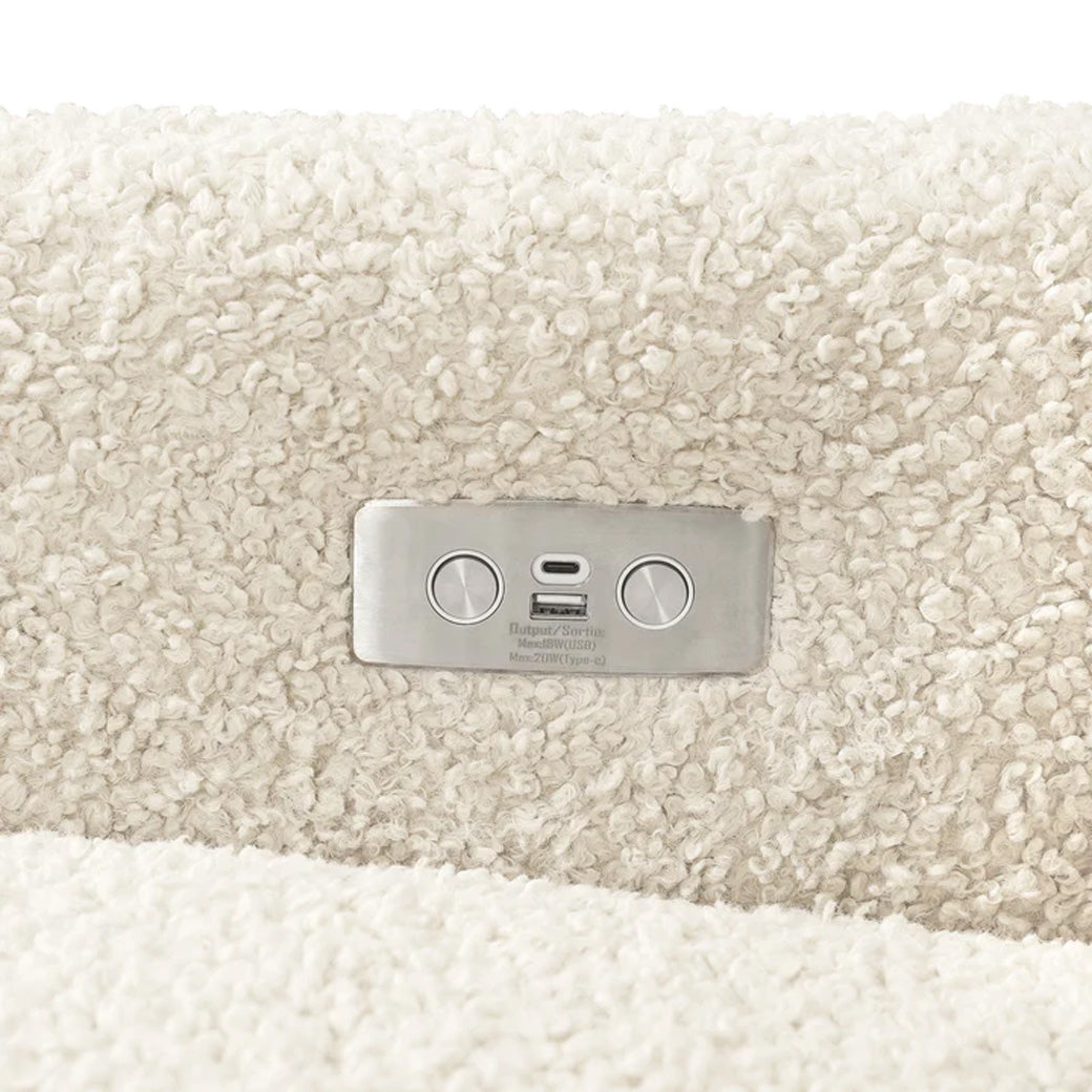 Closeup of USB port of Babyletto Kiwi Glider Recliner in -- Color_Almond Teddy Loop with Light Wood Base