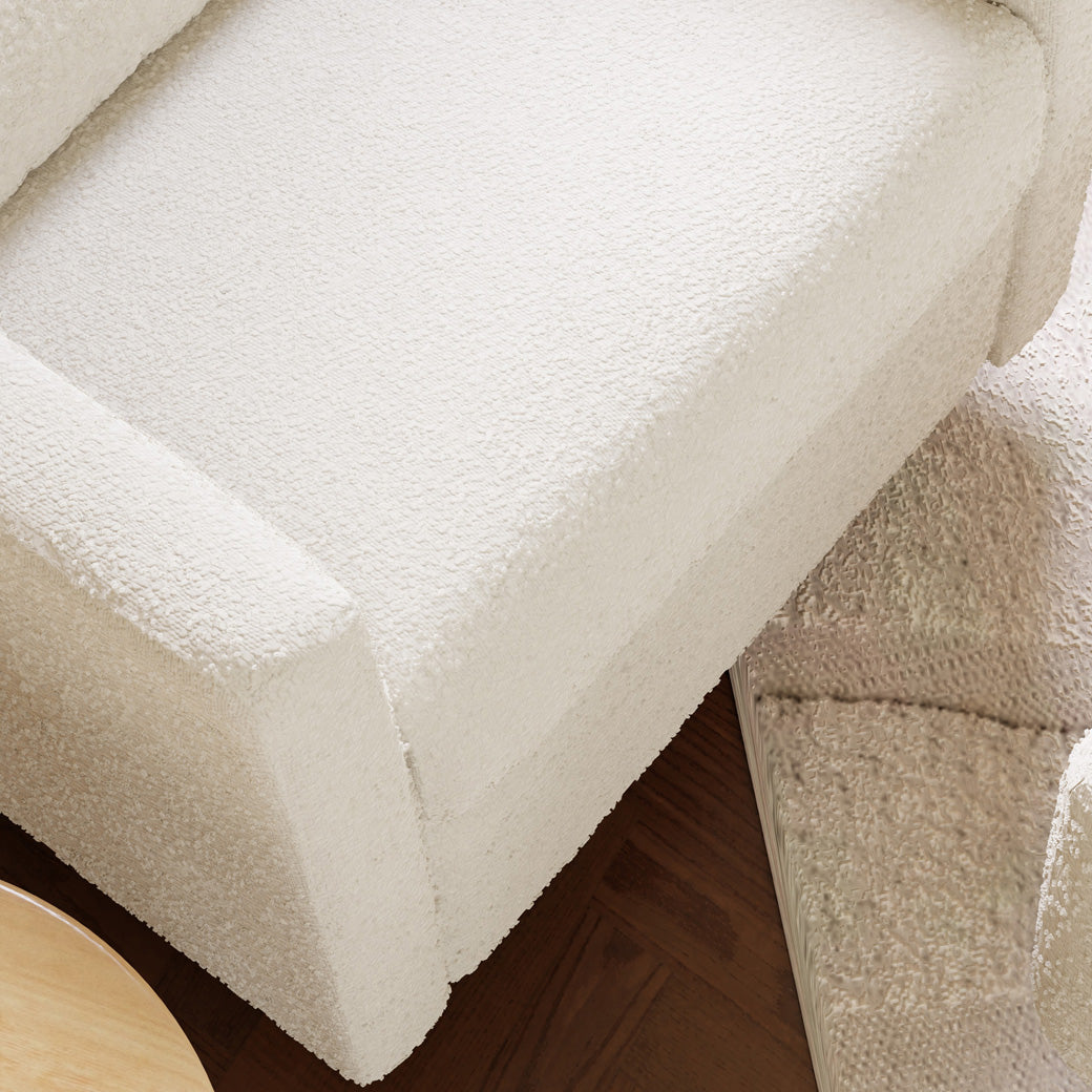 Closeup of the Babyletto Kiwi Glider Recliner with an ottoman material in -- Color_Ivory Boucle with Gold Base