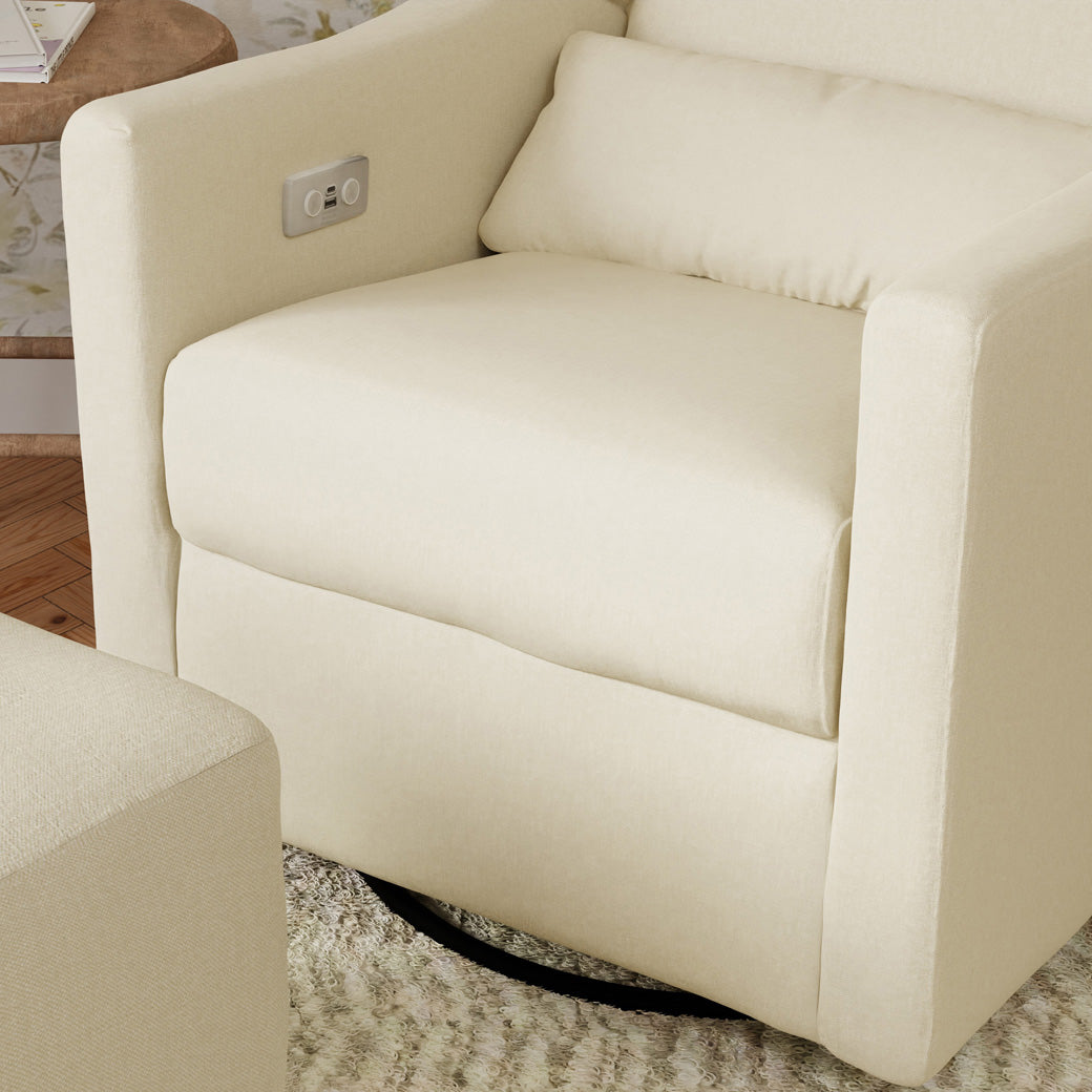 Closeup of Babyletto Kiwi Glider Recliner next to an ottoman  in -- Color_Performance Cream Eco-Weave