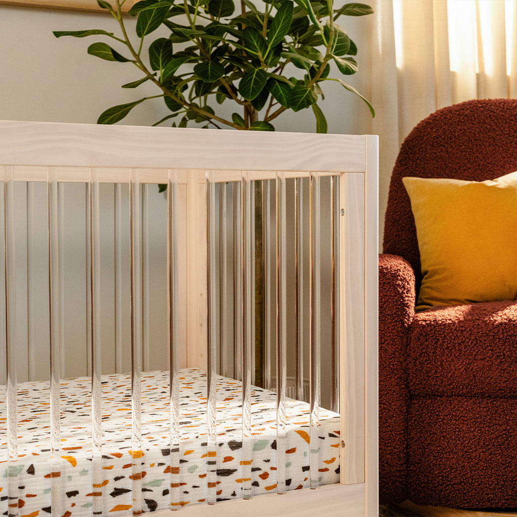 Closeup of the rails of The Babyletto Lolly 3-in-1 Convertible Crib in -- Color_Washed Natural / Acrylic