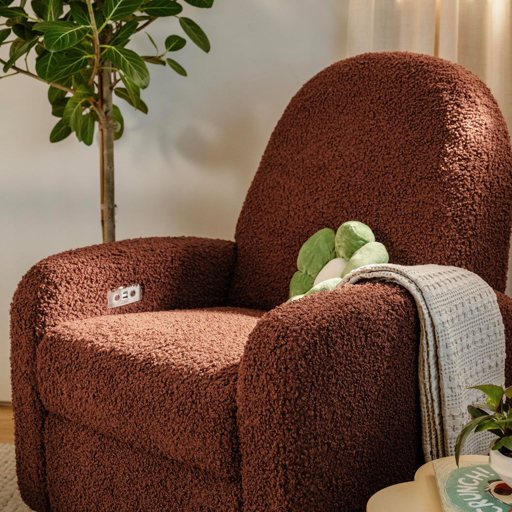 The Babyletto Nami Glider Recliner with flower pillow and blanket in -- Color_Rouge Teddy Loop with Light Wood Base