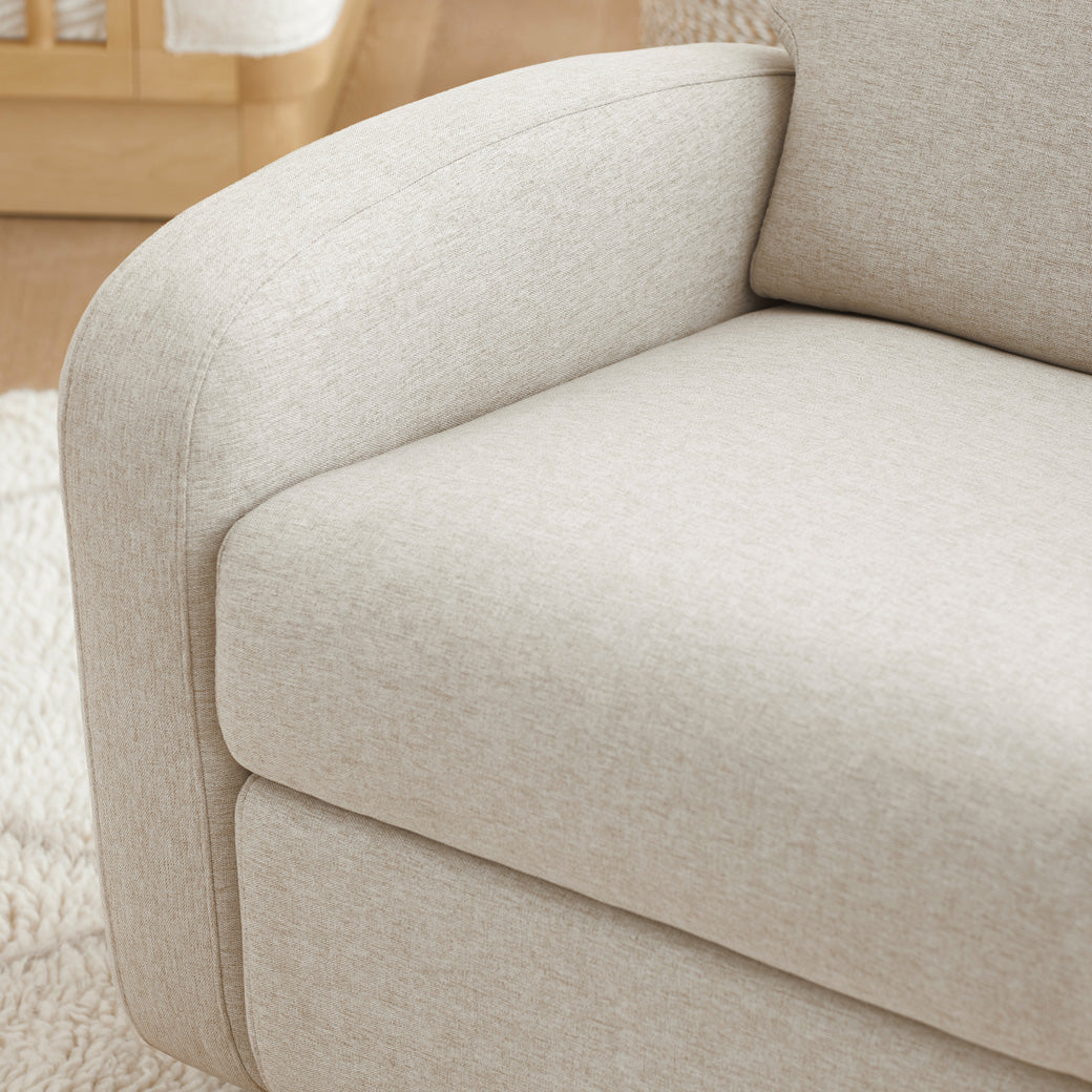 Closeup of the seat of the Babyletto Nami Glider Recliner in a room  in -- Color_Performance Beach Eco-Weave with Light Wood Base