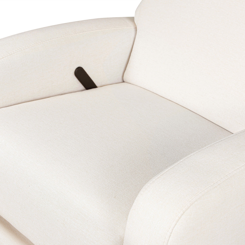 Closeup of the seat and the reclining lever of the Babyletto Nami Glider Recliner in -- Color_Performance Cream Eco-Weave with Light Wood Base