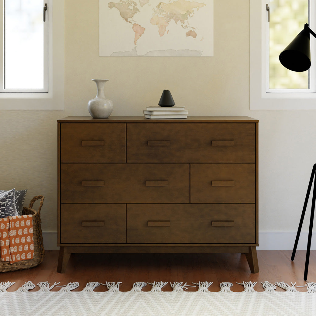Front view of Babyletto Scoot 6-Drawer Dresser next to a basket and lamp in -- Color_Natural Walnut