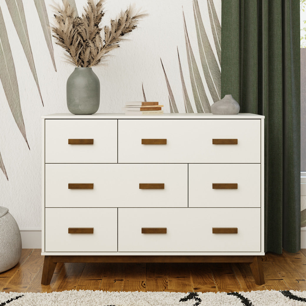 Front view of Babyletto Scoot 6-Drawer Dresser with decorations on top in -- Color_White / Natural Walnut