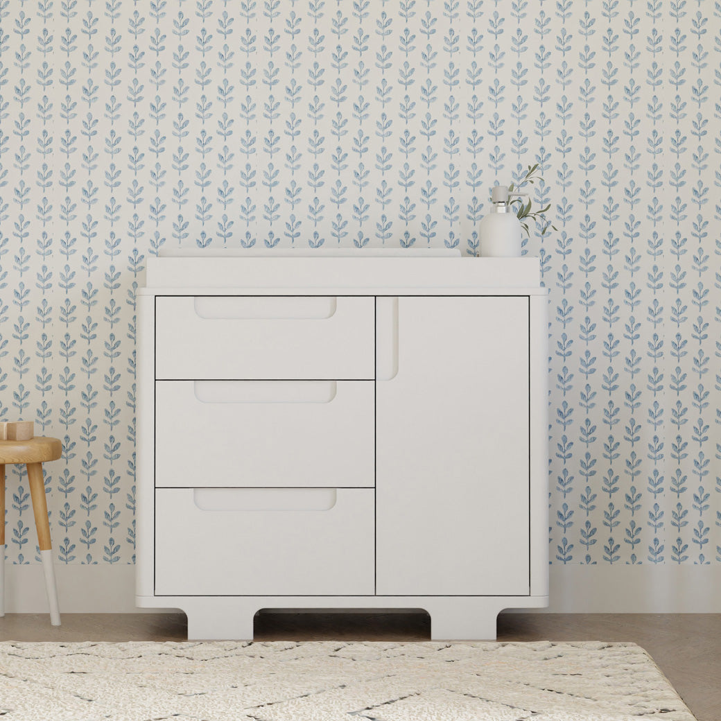 Front view of Babyletto Yuzu 3-Drawer Changer Dresser  next to a stool in -- Color_White