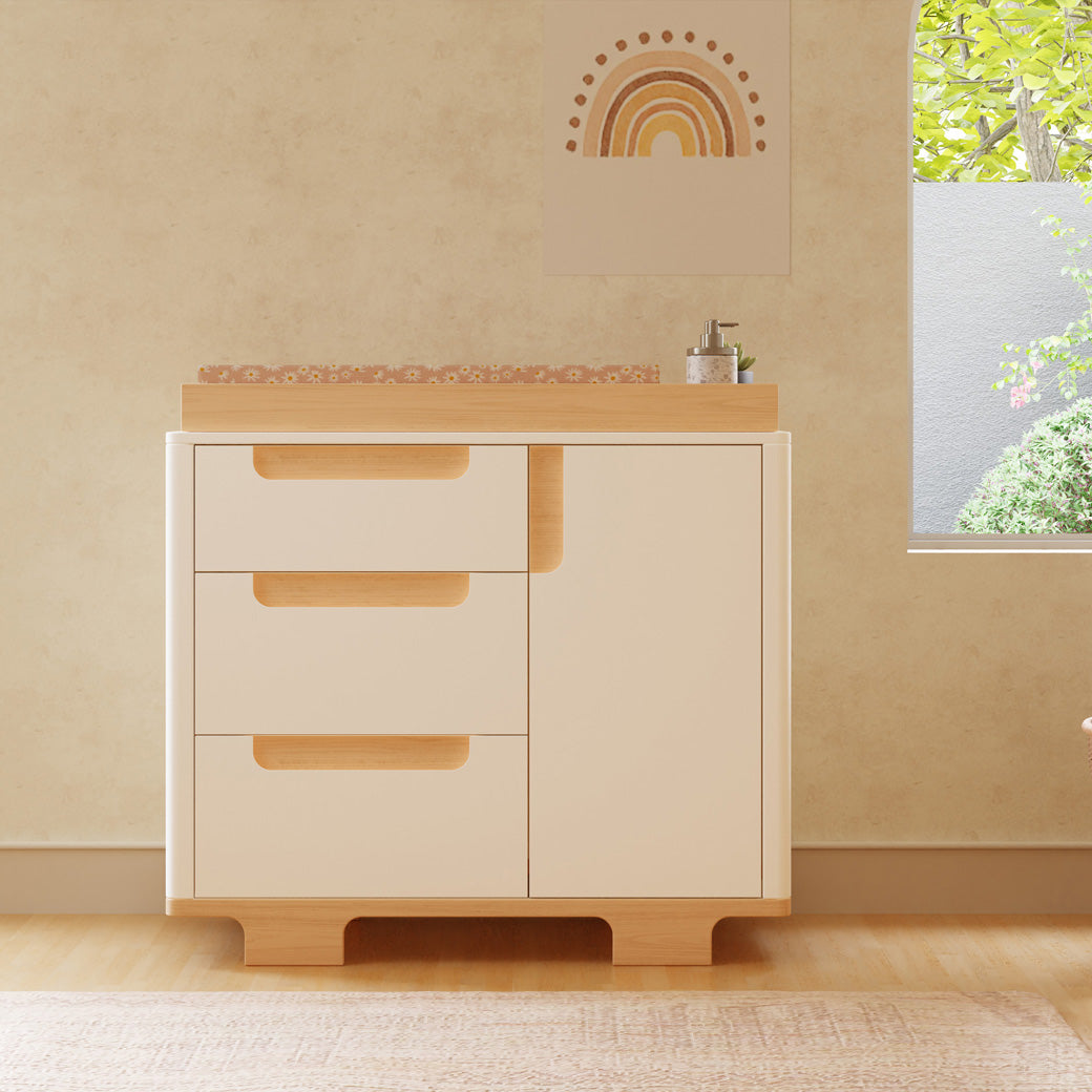 Front view of Babyletto Yuzu 3-Drawer Changer Dresser next to a window in -- Color_White / Natural