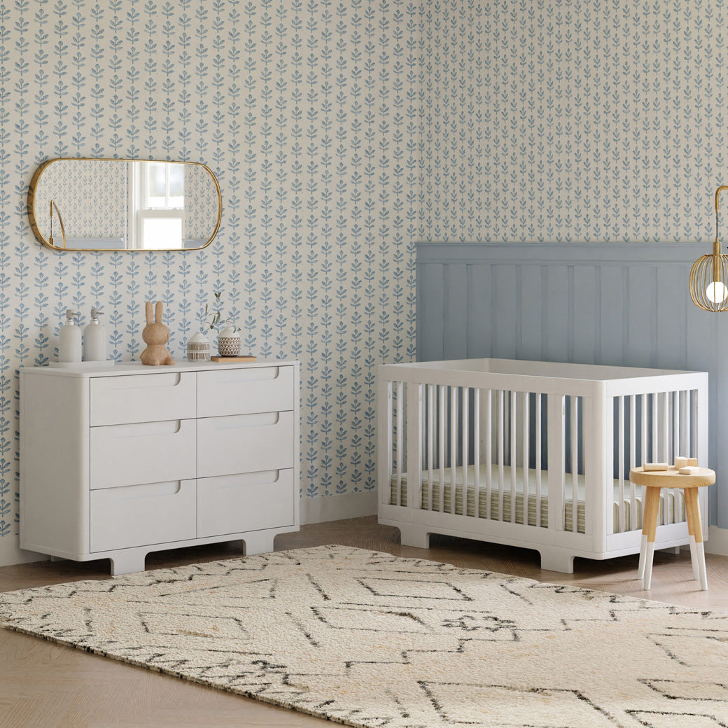 Babyletto Yuzu 6-Drawer Dresser next to a crib in -- Color_White