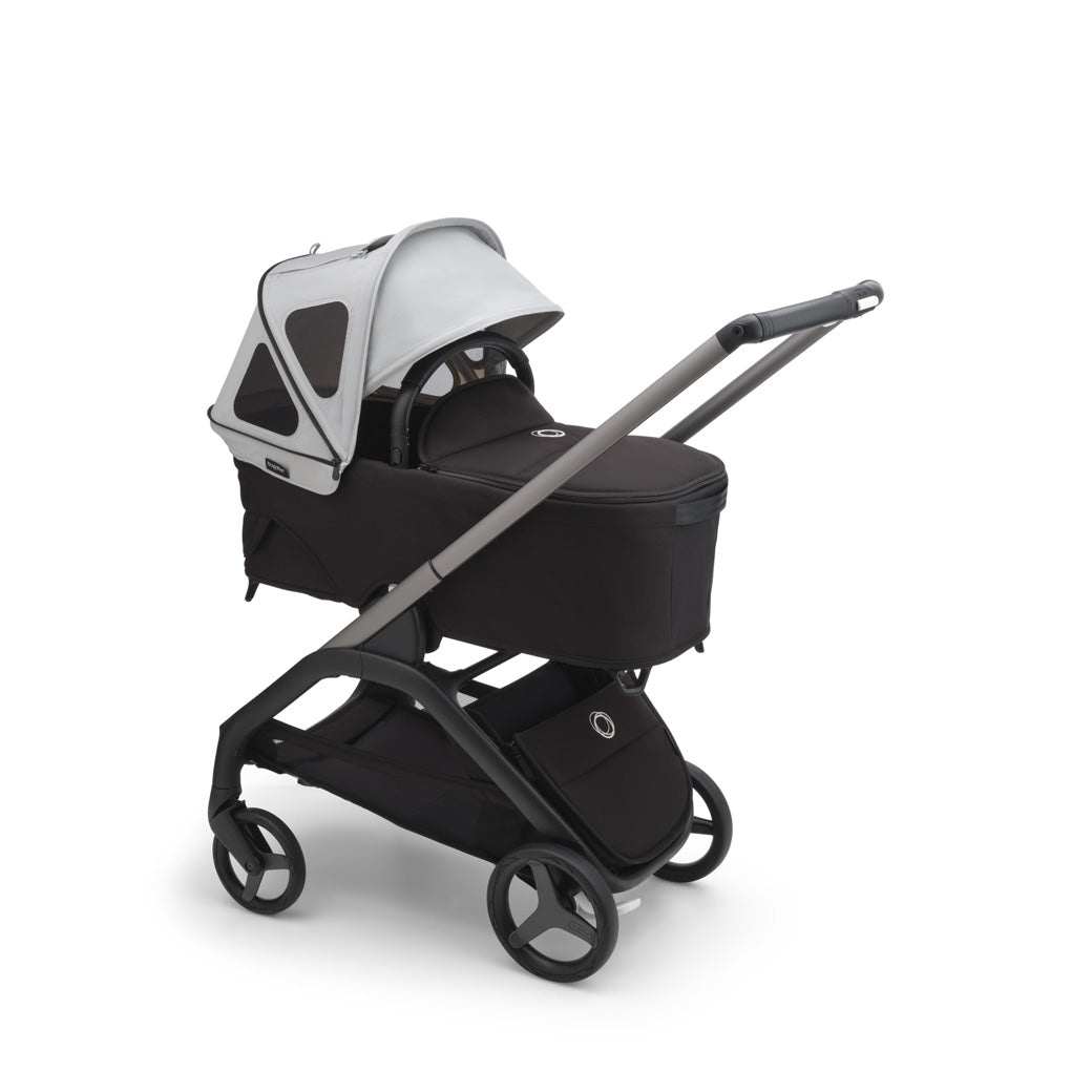 Bugaboo Dragonfly Breezy Sun Canopy open on a bassinet in -- Color_Misty Grey