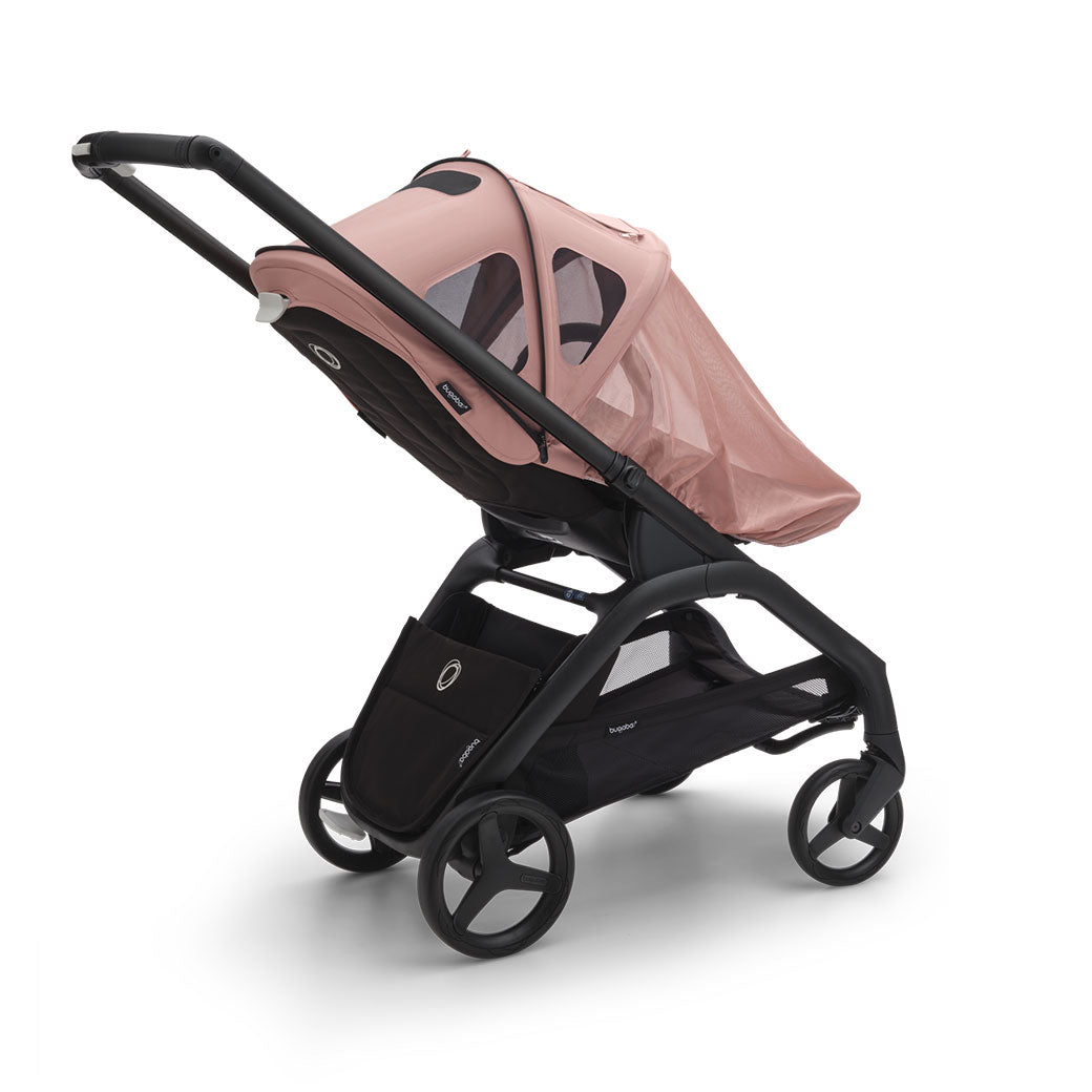 Bugaboo Dragonfly Breezy Sun Canopy on a stroller with the mosquito cover on in -- Color_Morning Pink