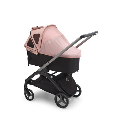 Bugaboo Dragonfly Breezy Sun Canopy on a bassinet with the mosquito cover over it in -- Color_Morning Pink