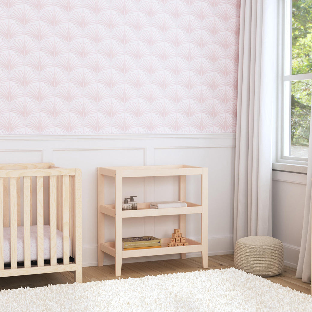 Carter's by DaVinci Colby Changing Table next to a crib and window in -- Color_Washed Natural