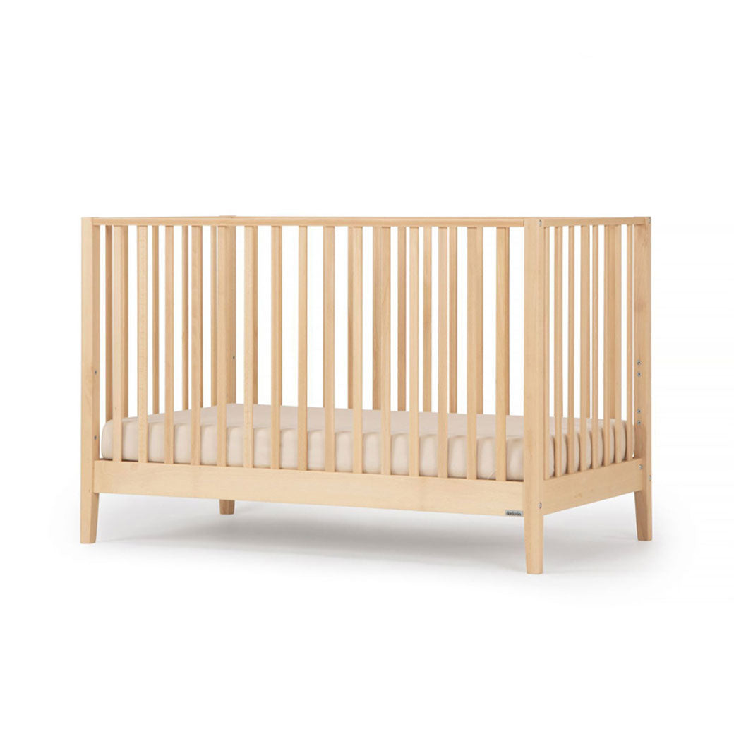 Angled view of Dadada Lala 3-in-1 Convertible Crib in - Color_Natural