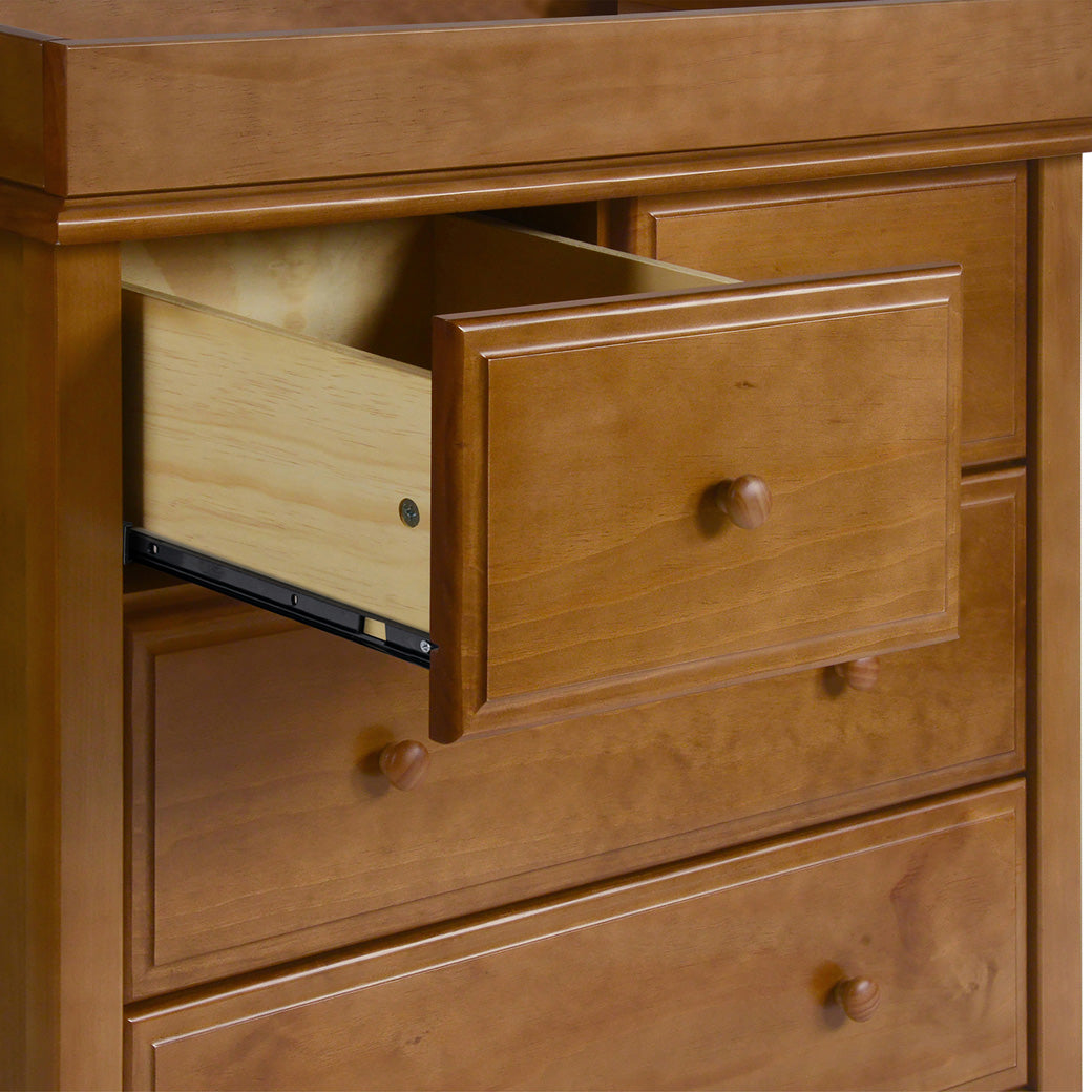 Closeup of DaVinci Autumn 4-Drawer Dresser with open drawer and changing tray on top  in -- Color_Chestnut