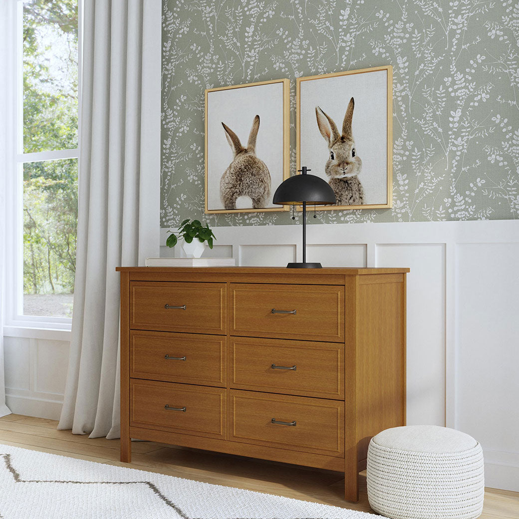 The DaVinci Charlie 6-Drawer Dresser next to a window in -- Color_Chestnut