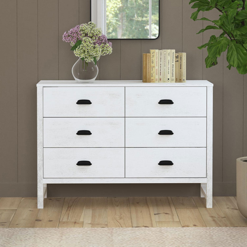 Front view of DaVinci Fairway 6-Drawer Double Dresser with a vase and books on top  in -- Color_Cottage White